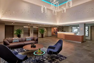 a lobby with a couch and chairs and a table at Fairfield Inn by Marriott Montreal Downtown in Montréal
