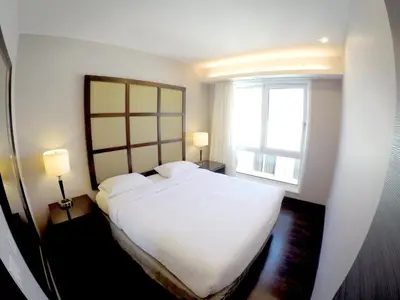 a bedroom with a large white bed and a window at M Montreal Hostel in Montréal