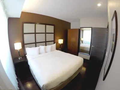 a bedroom with a large white bed and a window at M Montreal Hostel in Montréal