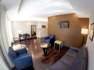 a hospital room with blue chairs and a table at M Montreal Hostel in Montréal