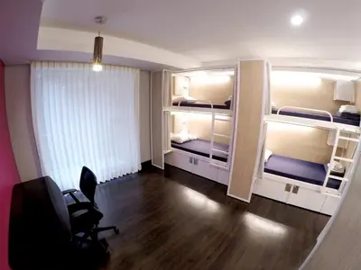 a room with two bunk beds and a chair at M Montreal Hostel in Montréal