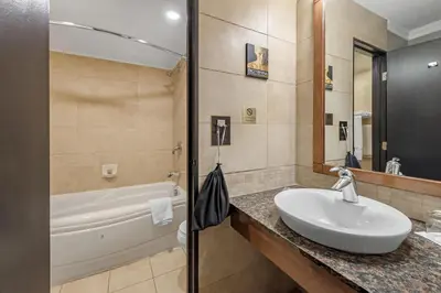 a bathroom with a sink and a tub at Best Western Hotel Universel Drummondville in Drummondville