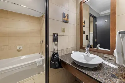 a bathroom with a sink and a bath tub at Best Western Hotel Universel Drummondville in Drummondville