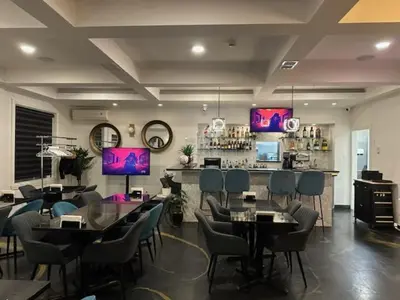 a restaurant with tables and chairs and a bar at Days Inn by Wyndham Montreal East in Montréal