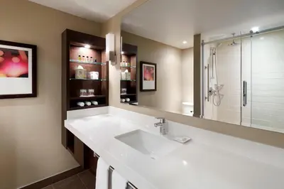 a bathroom with a white sink and a shower at Delta Hotels by Marriott Montreal in Montréal