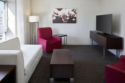 a living room with a couch and a tv at Delta Hotels by Marriott Montreal in Montréal