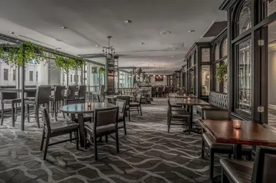 a restaurant with tables and chairs and windows at Delta Hotels by Marriott Montreal in Montréal
