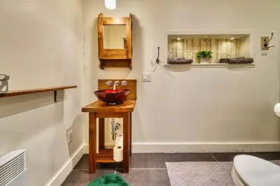 a bathroom with a bowl sink and a toilet at Perfect Loft for a Weekend in the Eastern Townships in Ayer's Cliff