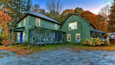 a green house sitting on top of a driveway at Perfect Loft for a Weekend in the Eastern Townships in Ayer's Cliff