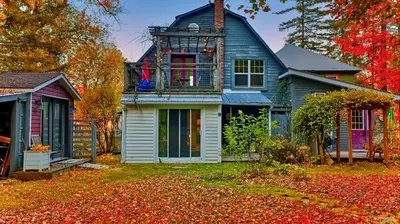 a house in the fall with leaves on the yard at Perfect Loft for a Weekend in the Eastern Townships in Ayer's Cliff