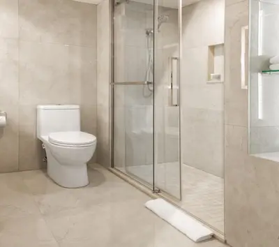 a bathroom with a toilet and a glass shower at Chateau Vaudreuil in Vaudreuil-Dorion