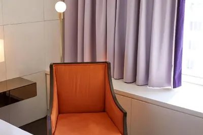 an orange chair sitting in front of a window at Hotel St Paul, Montreal, a Member of Design Hotels in Montréal