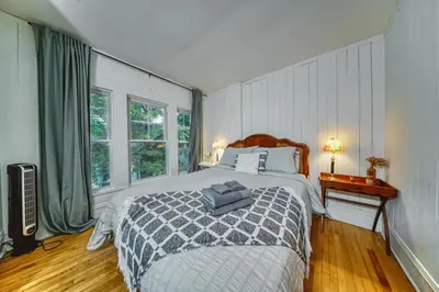 a bedroom with a bed and a large window at Family Winter Home in the Eastern Townships in Ayer's Cliff