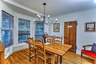 a dining room with a wooden table and chairs at Family Winter Home in the Eastern Townships in Ayer's Cliff