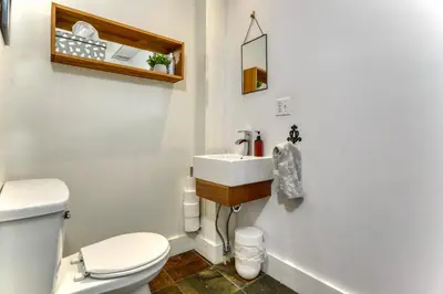 a bathroom with a white toilet and a sink at Family Winter Home in the Eastern Townships in Ayer's Cliff
