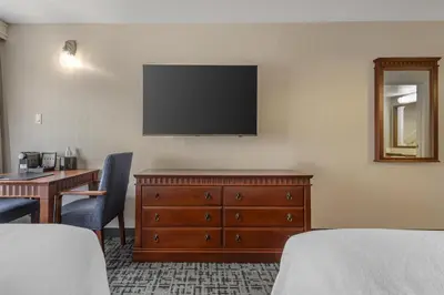 a hotel room with a television on the wall at Best Western Hotel Brossard in Brossard