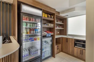 a refrigerator filled with lots of drinks in a kitchen at Best Western Hotel Brossard in Brossard