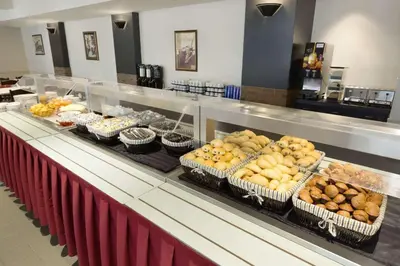 a buffet line with many different types of pastries at Travelodge by Wyndham Montreal Centre in Montréal