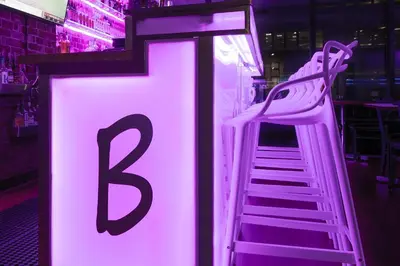 a neon sign with a letter b and a ladder at Travelodge by Wyndham Montreal Centre in Montréal