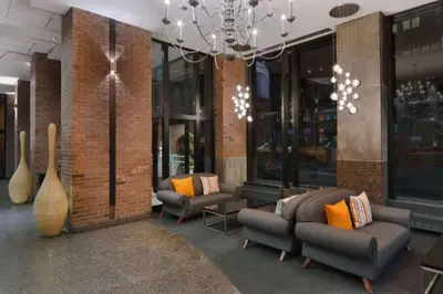 a lobby with couches and chairs and a chandelier at Travelodge by Wyndham Montreal Centre in Montréal