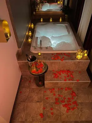 an overhead view of a bath tub with red flowers at Hotel Dorion in Montréal