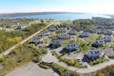 an aerial view of a large estate with a lake at Le Philémon Club Azur plage Memphrémagog in Magog-Orford