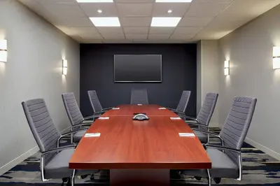 a conference room with a large wooden table and chairs at Fairfield Inn & Suites by Marriott Montreal Airport in Dorval