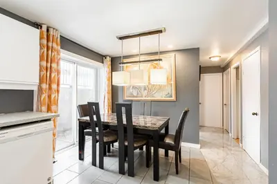 a dining room with a table and chairs at Chez Joe - CITQ #3I74I4 in Terrebonne