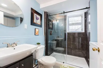 a bathroom with a shower and a toilet and a sink at Chez Joe - CITQ #3I74I4 in Terrebonne
