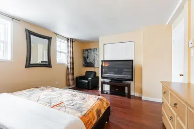 a bedroom with a bed and a flat screen tv at Chez Joe - CITQ #3I74I4 in Terrebonne