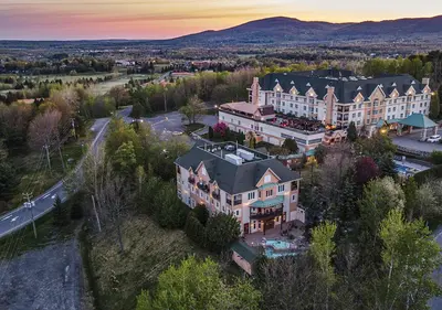 an aerial view of a large house in a town at Hotel Chateau Bromont in Bromont