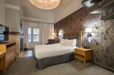 a hotel room with a bed and a television at Hotel Chateau Bromont in Bromont