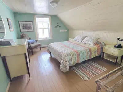 a bedroom with a bed and a desk and a window at À la croisée des sommets in Notre-Dame-Des-Bois