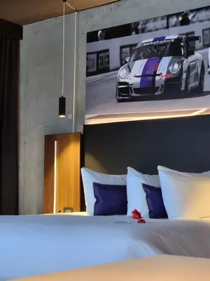 a bedroom with a bed with a car on the wall at Grand Hotel TiMES Blainville-Mirabel in Blainville