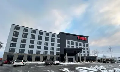 a hotel building with a sign that reads times at Grand Hotel TiMES Blainville-Mirabel in Blainville