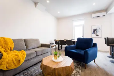 a living room with a couch and two chairs and a table at Huge 2 Bdr with Balcony in Mile End by Den Stays in Montréal