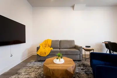 a living room with a couch and a coffee table at Huge 2 Bdr with Balcony in Mile End by Den Stays in Montréal