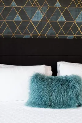 a blue pillow sitting on top of a bed at Stunning 1 Bedroom in Mile End by Den Stays in Montréal