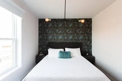 a bedroom with a bed with a blue pillow on it at Stunning 1 Bedroom in Mile End by Den Stays in Montréal