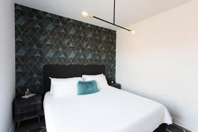 a bedroom with a white bed with a blue pillow at Stunning 1 Bedroom in Mile End by Den Stays in Montréal