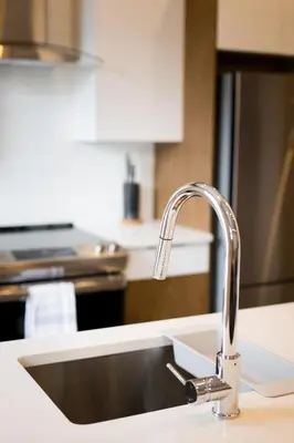 a kitchen counter with a sink and aaucet at Stunning 1 Bedroom in Mile End by Den Stays in Montréal