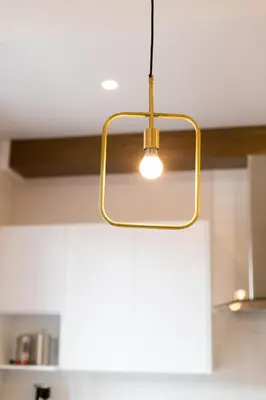 a light hanging from a ceiling in a kitchen at Stunning 1 Bedroom in Mile End by Den Stays in Montréal