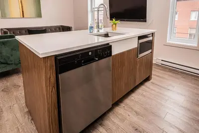 a kitchen with a sink and a dishwasher at 2 Bedroom Luxury in the Mile End by Den Stays in Montréal