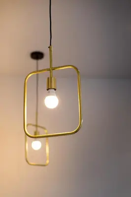 a light that is hanging from a ceiling at Light Filled 2 Bdr Unit in Mile End by Den Stays in Montréal