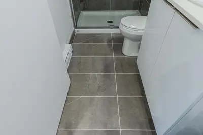a bathroom with a toilet and a shower at Brand New and Perfectly Located Flat in Le Plateau by Den Stays in Montréal