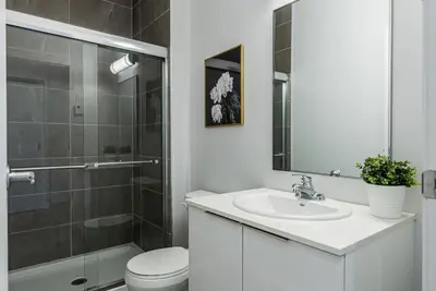 a bathroom with a toilet and a sink and a shower at Brand New and Perfectly Located Flat in Le Plateau by Den Stays in Montréal