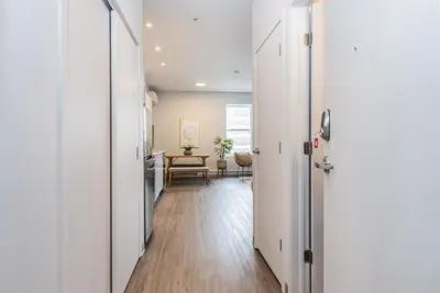 a hallway with white doors and a dining room at Brand New and Perfectly Located Flat in Le Plateau by Den Stays in Montréal