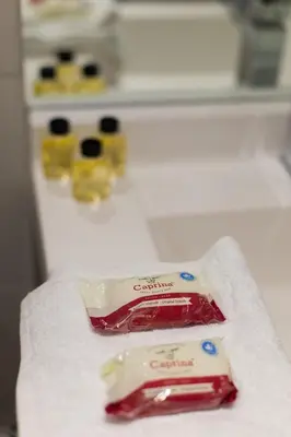 a package of candy on a towel in front of a refrigerator at Studio Palms Steps from JeanTalon Market Full Bath by Den Stays in Montréal