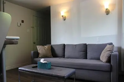 a living room with a couch and a table at Le Marigot in Vaudreuil-Dorion