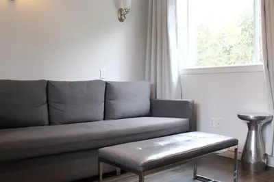 a living room with a couch and a table at Le Marigot in Vaudreuil-Dorion